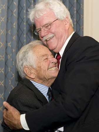 Dr. T. Berry Brazelton receives a 90th birthday hug from Congressman George Miller